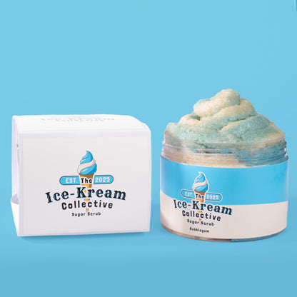 The Ice-Kream Collective Bubblegum sugar scrub in a clear jar with blue and cream packaging, displayed next to its branded box on a pastel blue background.
