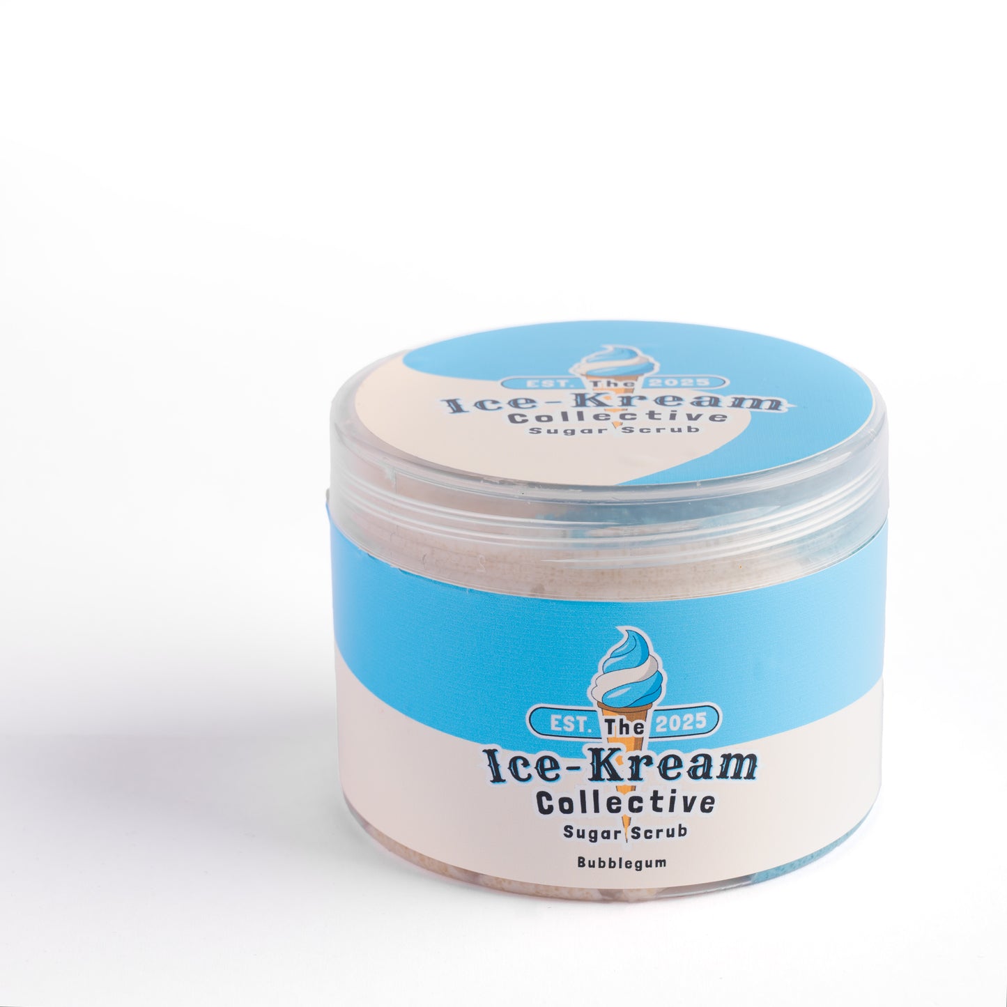 The Ice-Kream Collective Bubblegum sugar scrub in a round jar with blue and cream packaging, labeled EST. 2025, on a white studio background.