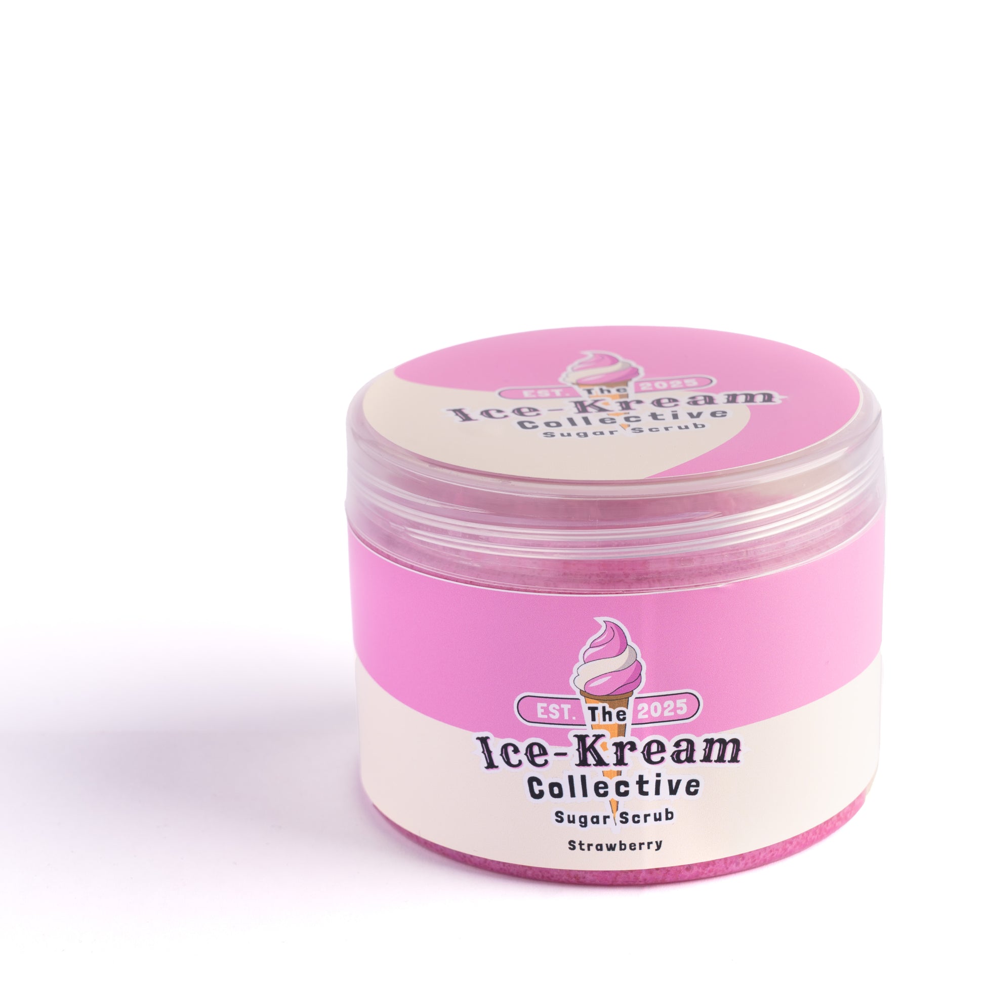 The Ice-Kream Collective Strawberry sugar scrub in a round jar with pink and cream packaging, labeled EST. 2025, on a white studio background.